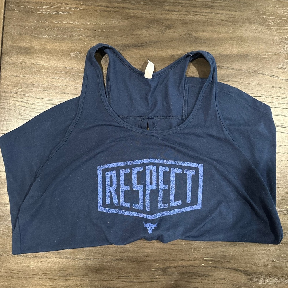 This is a navy blue Under Armour tank top with light blue writing.